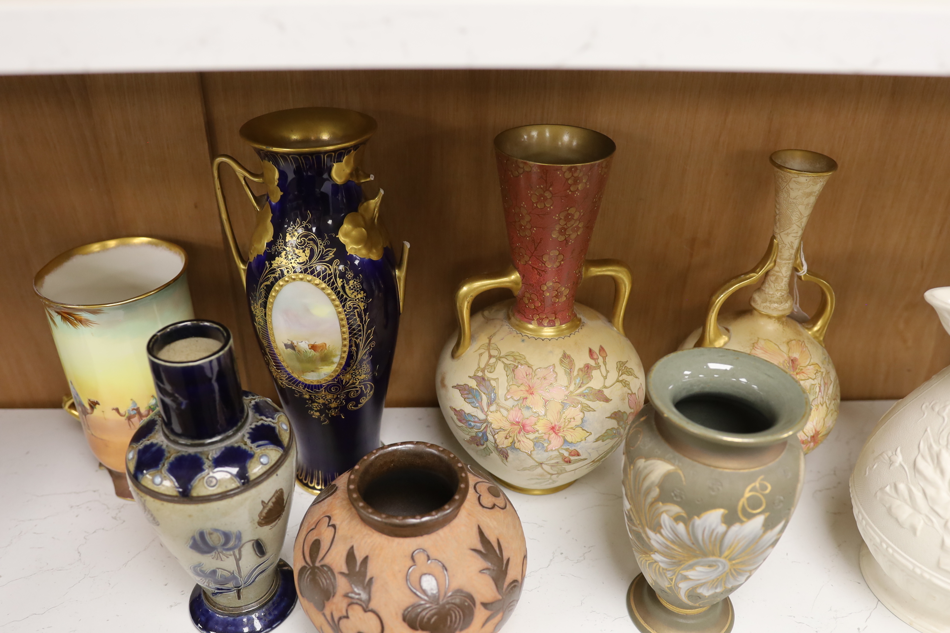 C.H Bailey - a Fulham vase (a.f.), two Doulton Burslem gilded vases, three other Doulton vases and a Victorian jug, largest 27cm high (7)